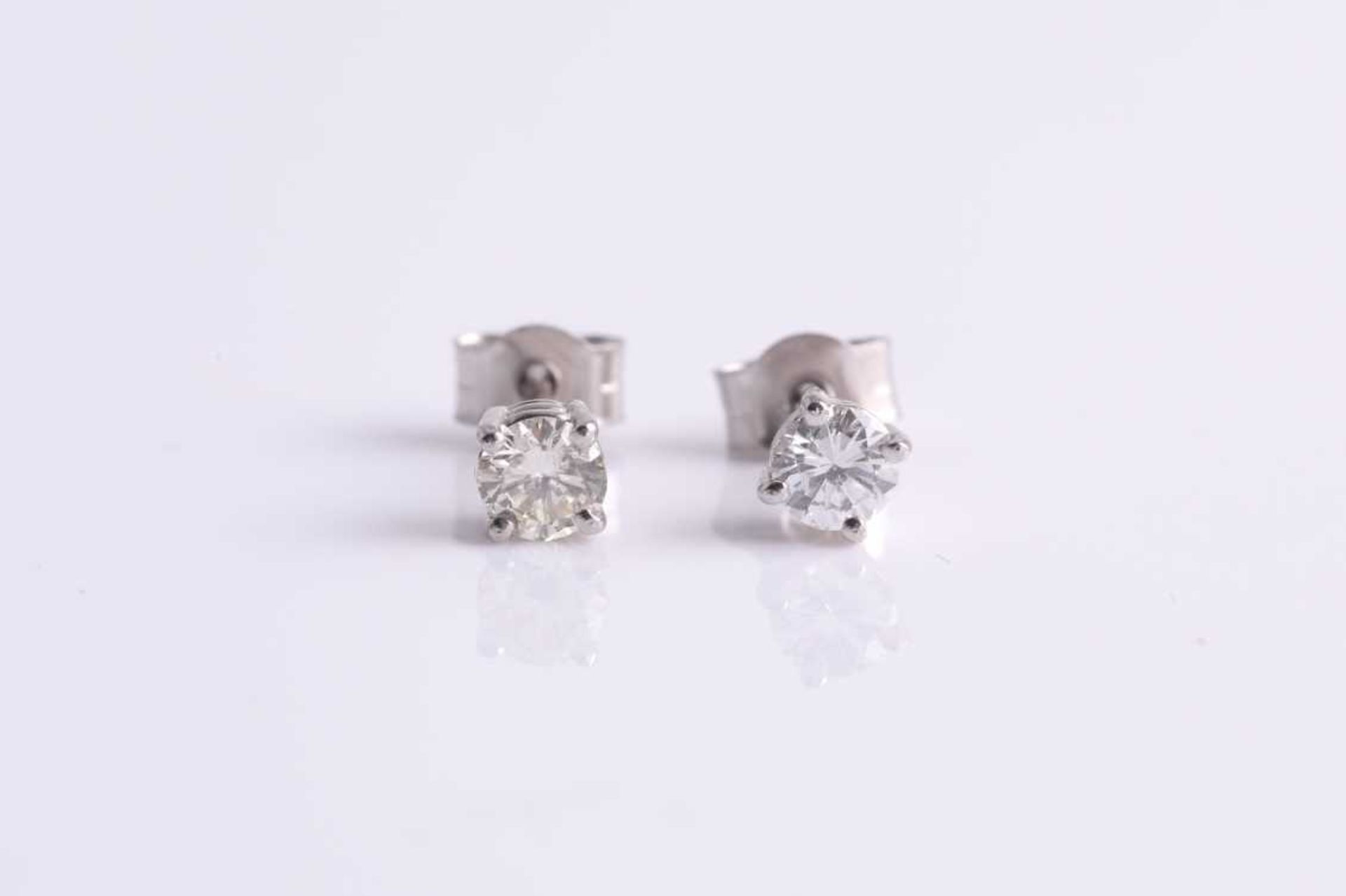 A pair of round brilliant-cut diamond ear studs, the diamonds of approximately 0.34 carats