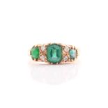 An Edwardian 18ct gold, green garnet-topped doublet and diamond half-hoop ring, the three