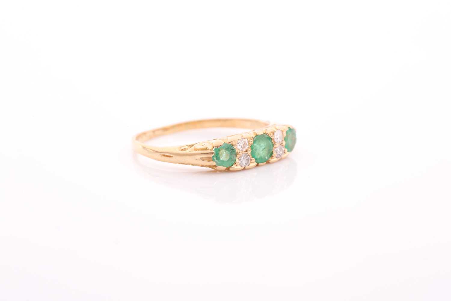 An early 20th century gold, emerald and diamond carved half-hoop ring, the three slightly - Image 4 of 4