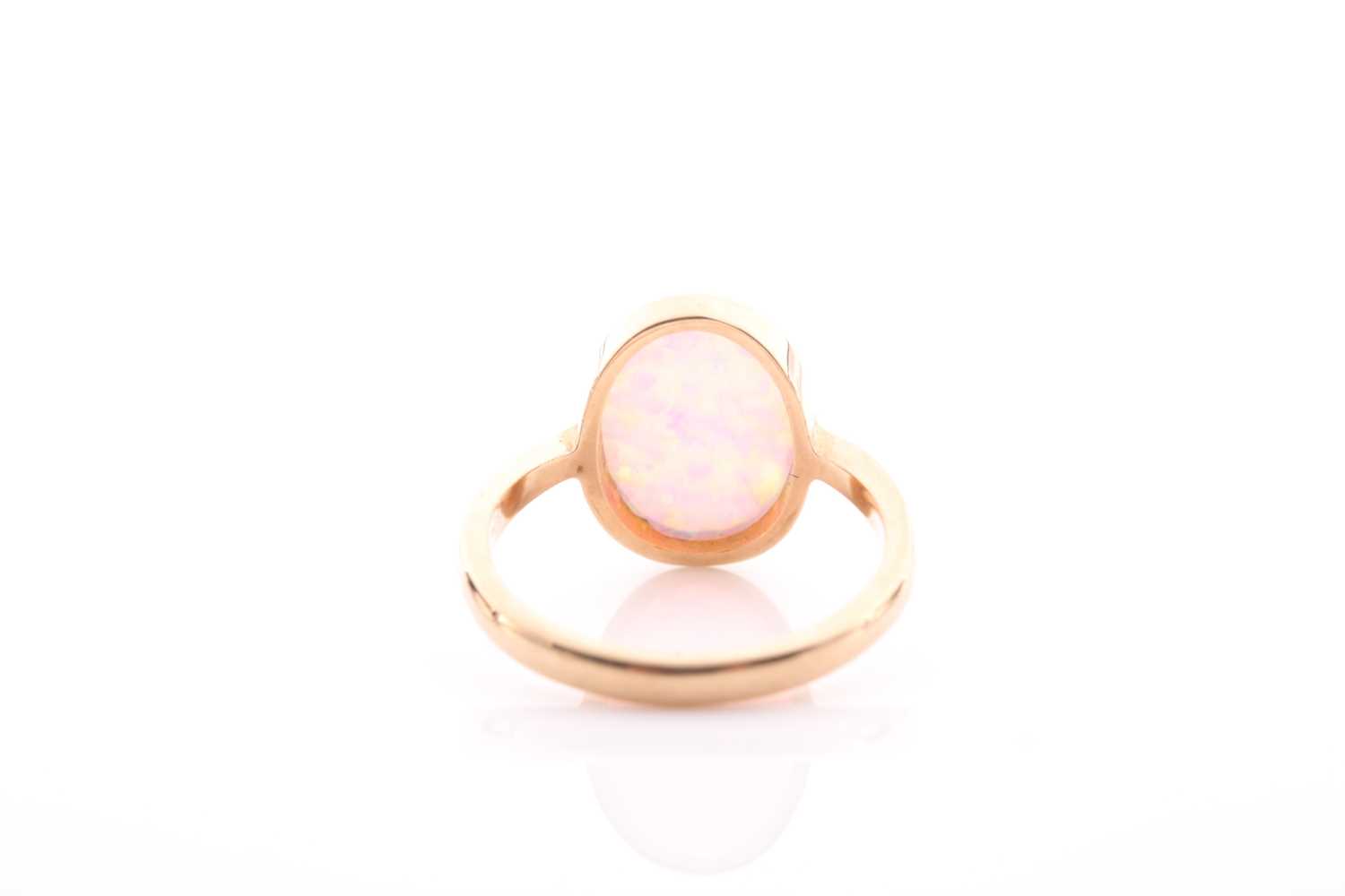 A single stone opal ring, the oval opal in rub-over mount to plain 9 carat gold shank, opal 14mm x - Image 4 of 4