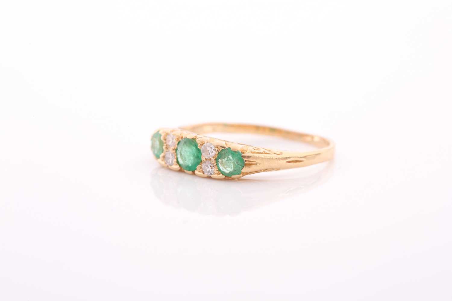 An early 20th century gold, emerald and diamond carved half-hoop ring, the three slightly - Image 3 of 4