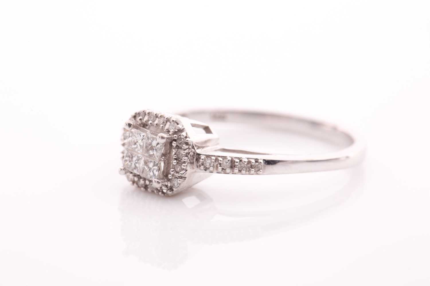 A 14ct white gold and diamond cluster ring, inset with four square-cut diamonds to centre within a