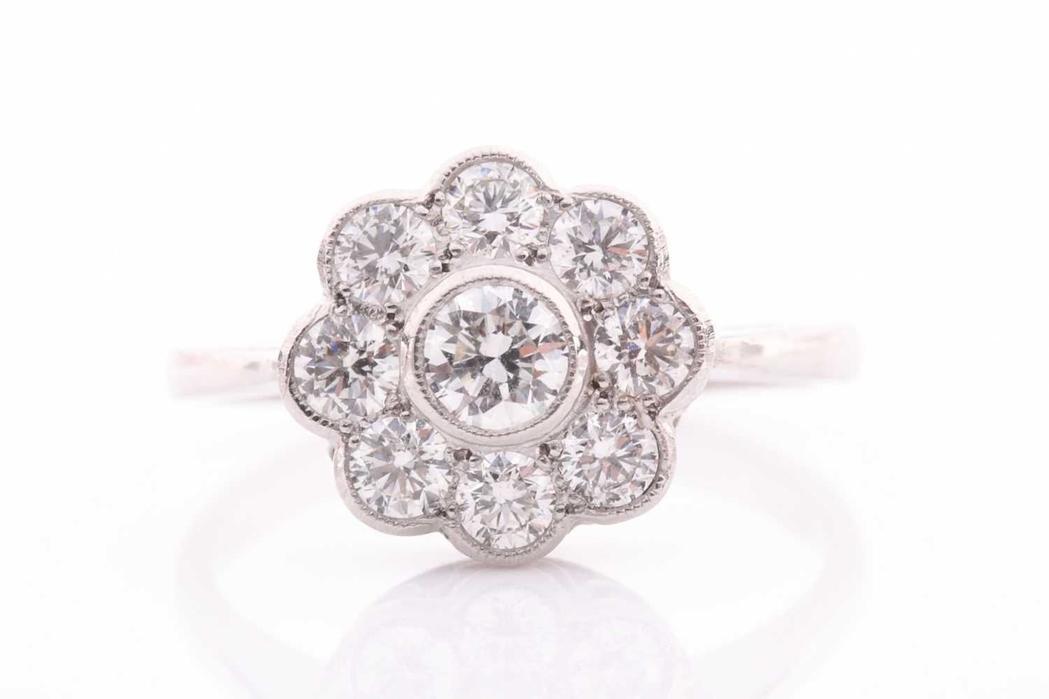 A platinum and diamond daisy cluster ring, set with round-cut diamonds of approximately 1.0 carats