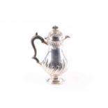 A late Victorian silver baluster hot water jug, London 1889, makers mark rubbed, with ebony finial