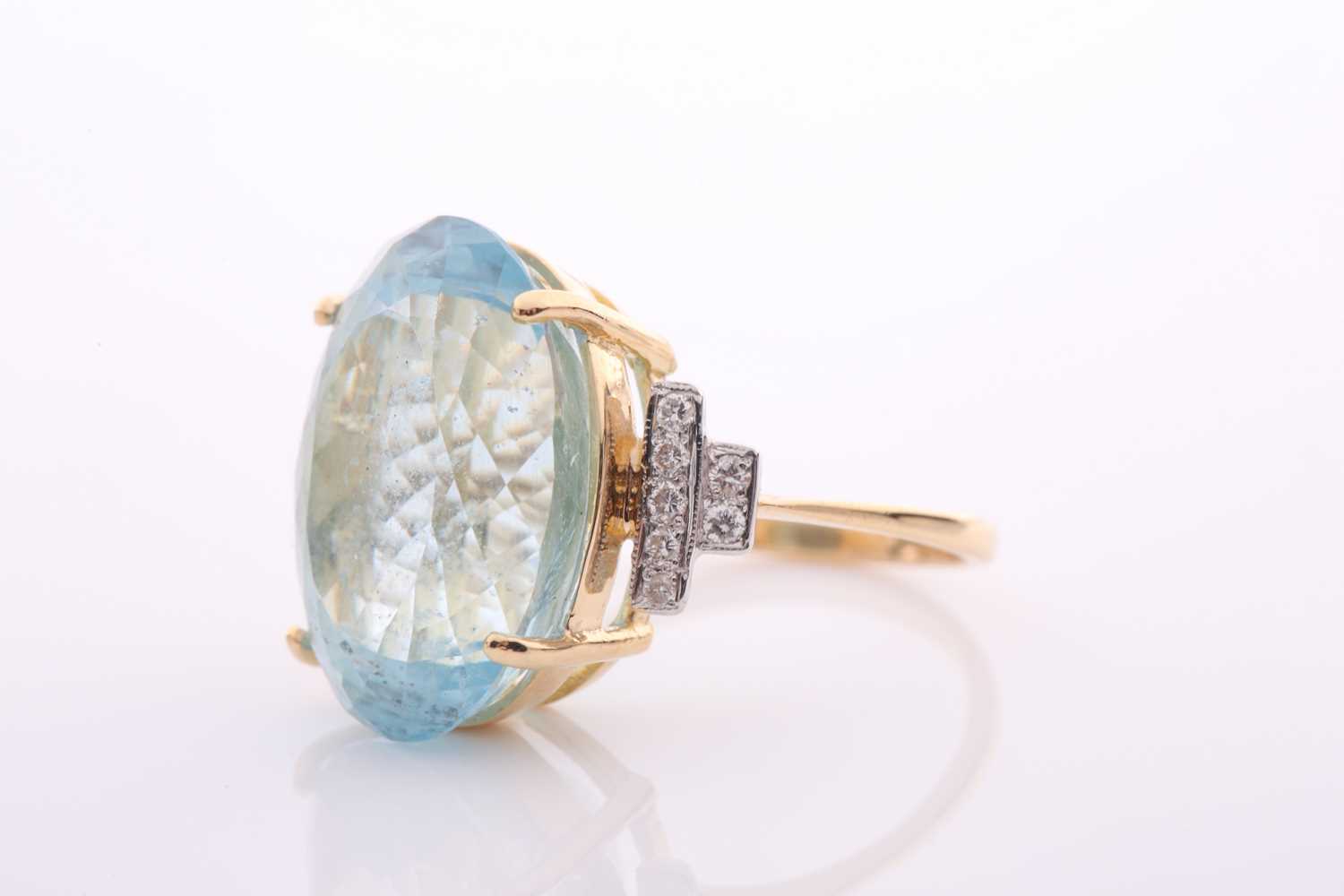 A modern aquamarine and diamond dress ring, centred with a large oval mixed-cut aquamarine, - Image 6 of 6