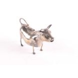 A Continental silver cow creamer, circa 1900, standing on all fours, the lid with stylised bee,