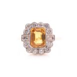 A yellow sapphire and diamond cluster ring; the mixed rectangular cut sapphire millegrain mounted