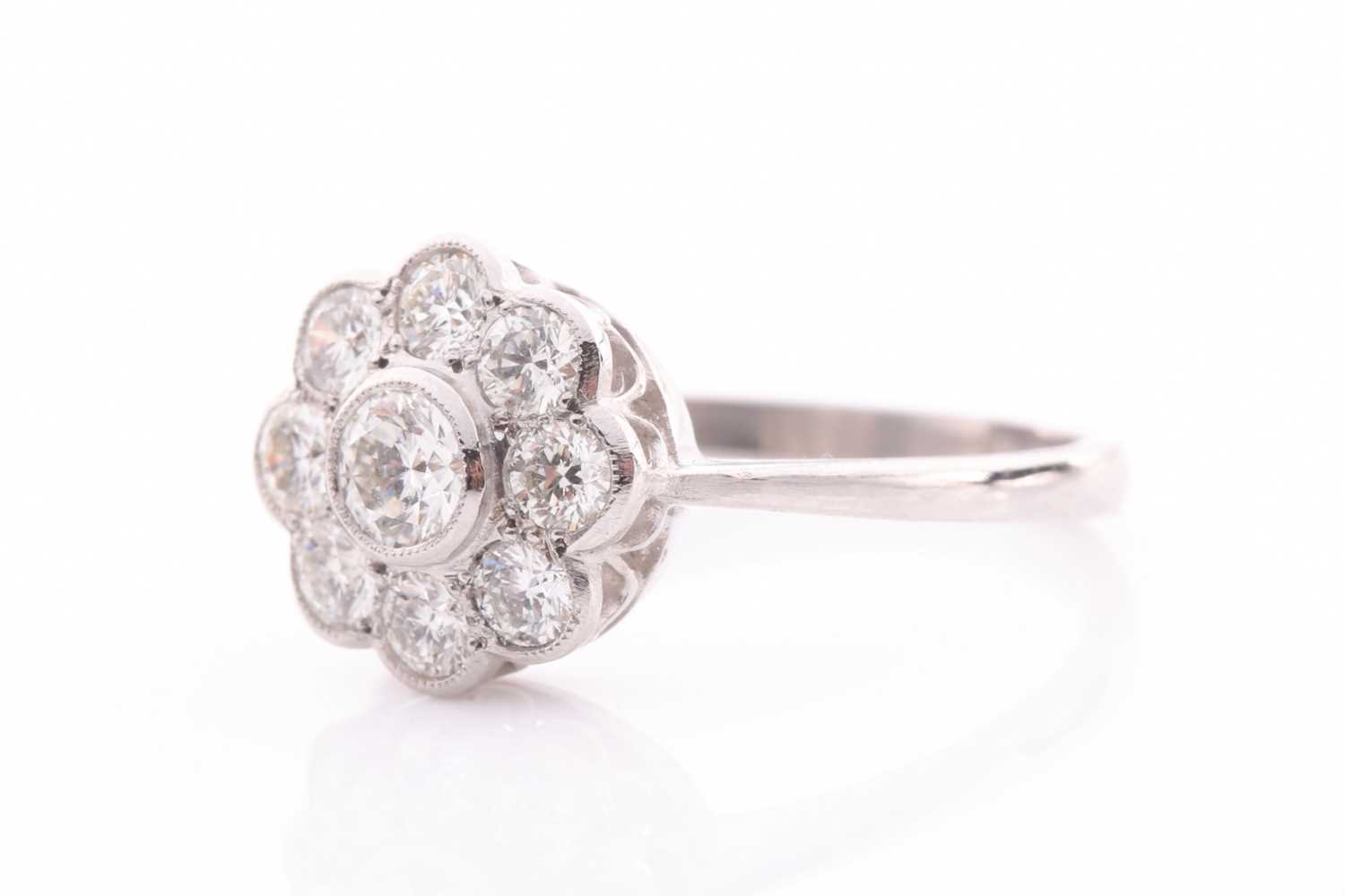 A platinum and diamond daisy cluster ring, set with round-cut diamonds of approximately 1.0 carats - Image 3 of 4