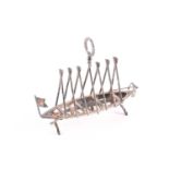 A silver plated six division toast rack in the form of a boat with oars up, the handle in the form