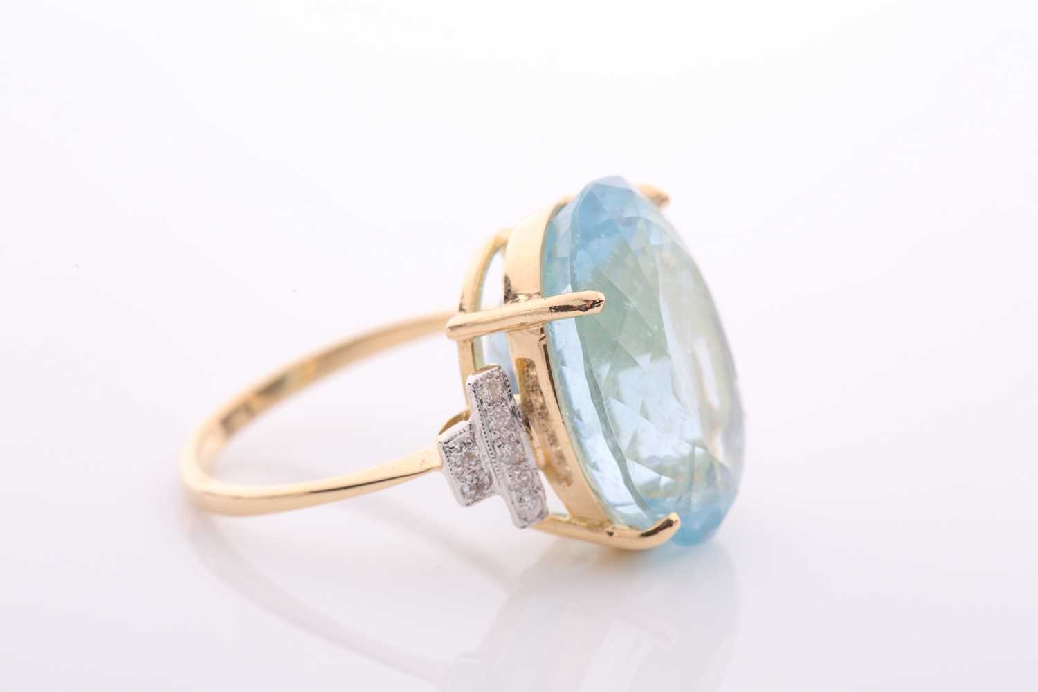 A modern aquamarine and diamond dress ring, centred with a large oval mixed-cut aquamarine, - Image 2 of 6