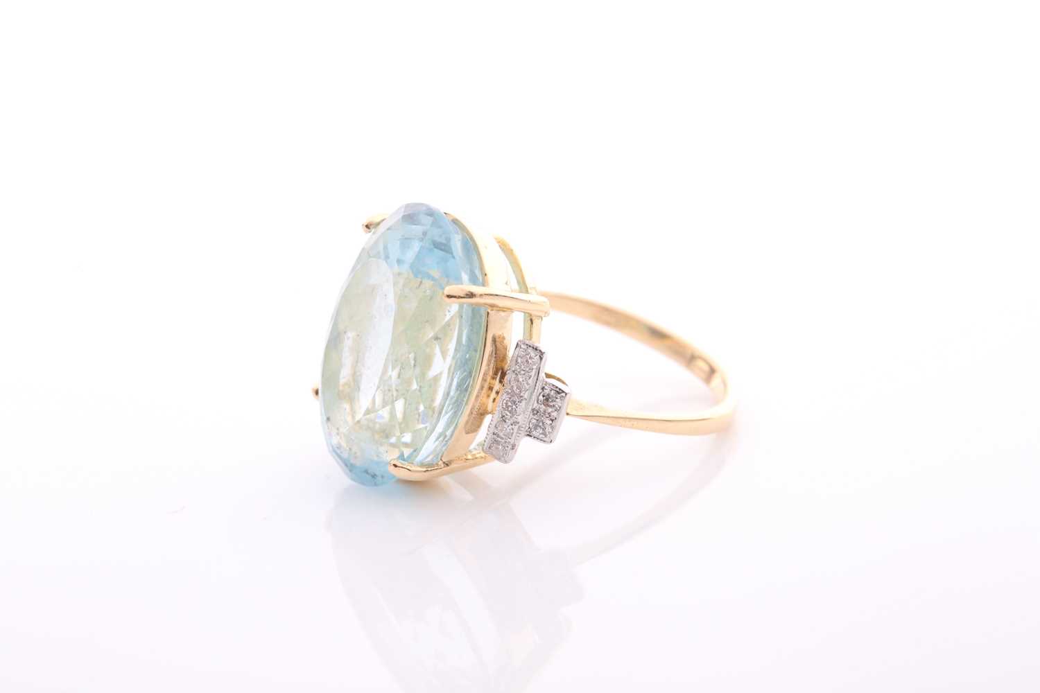 A modern aquamarine and diamond dress ring, centred with a large oval mixed-cut aquamarine, - Image 4 of 6