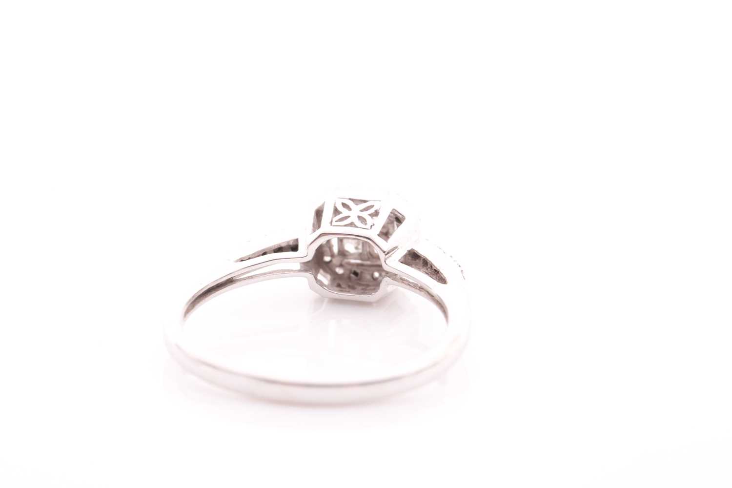 A 14ct white gold and diamond cluster ring, inset with four square-cut diamonds to centre within a - Image 3 of 4