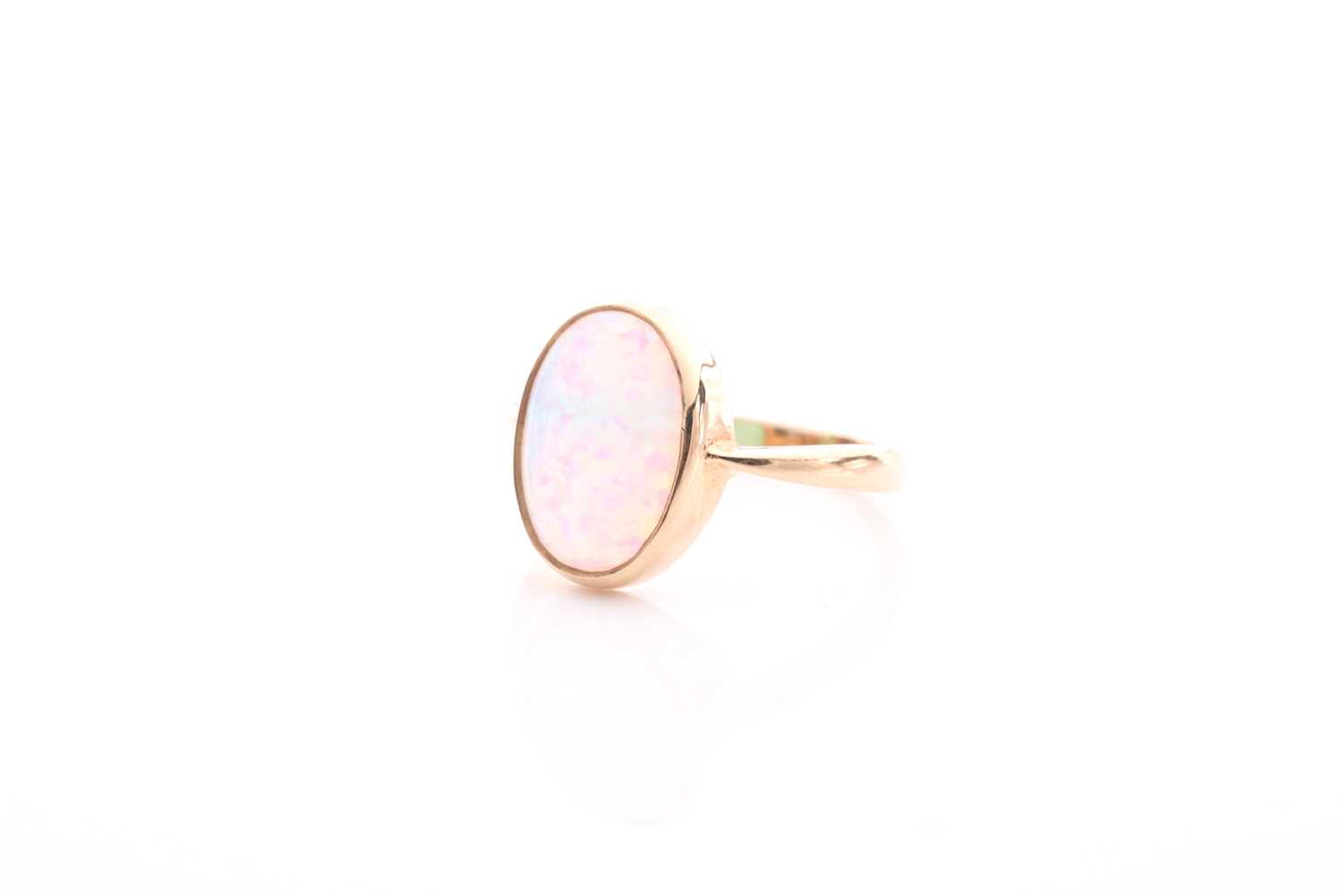 A single stone opal ring, the oval opal in rub-over mount to plain 9 carat gold shank, opal 14mm x - Image 2 of 4