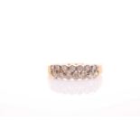 A two row 18 carat gold and diamond half hoop ring; the fourteen round brilliant cut diamonds in
