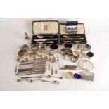 A mixed collection of silver napkin rings, cruet items and silver-handled flatware and two
