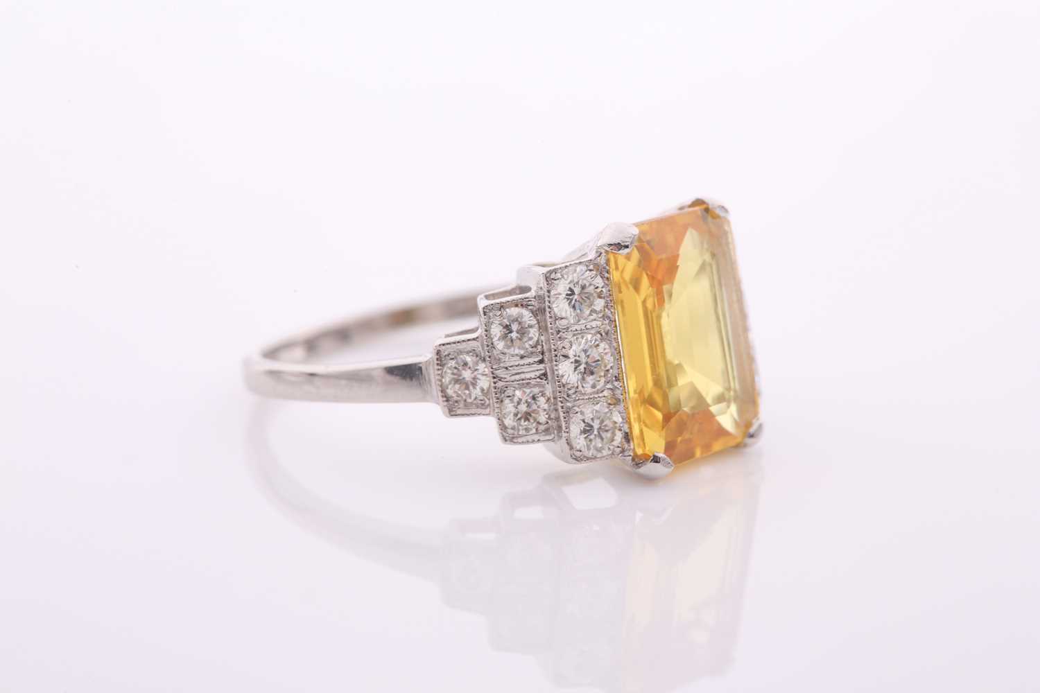 A modern treated yellow sapphire and diamond dress ring, centred with a rectangular step-cut - Image 3 of 4