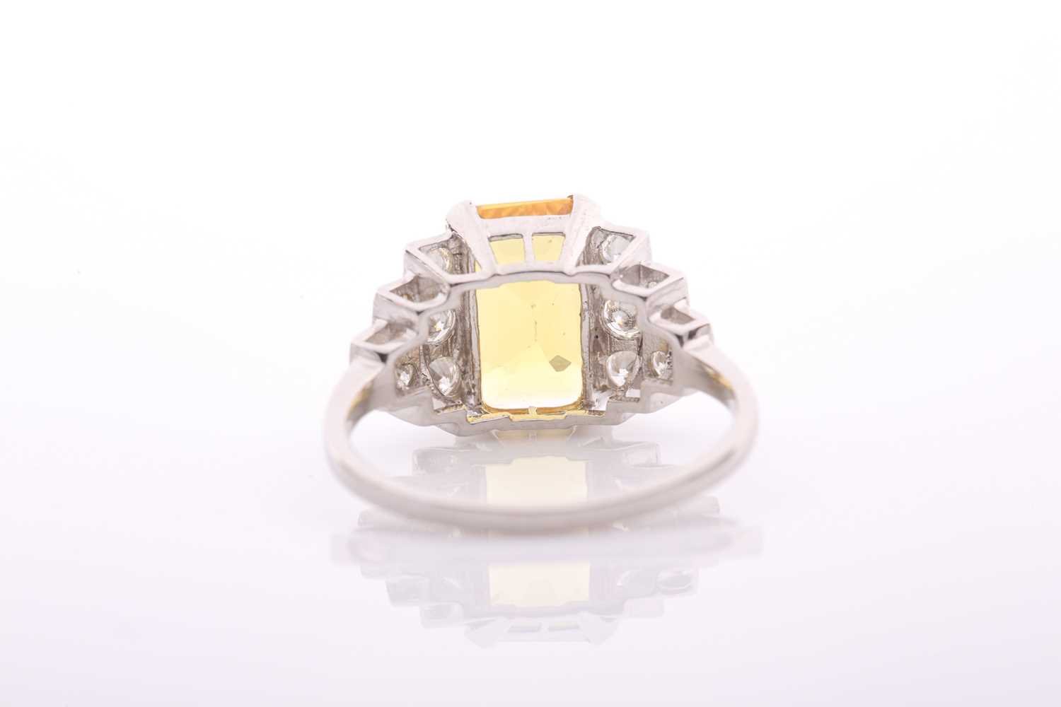 A modern treated yellow sapphire and diamond dress ring, centred with a rectangular step-cut - Image 4 of 4