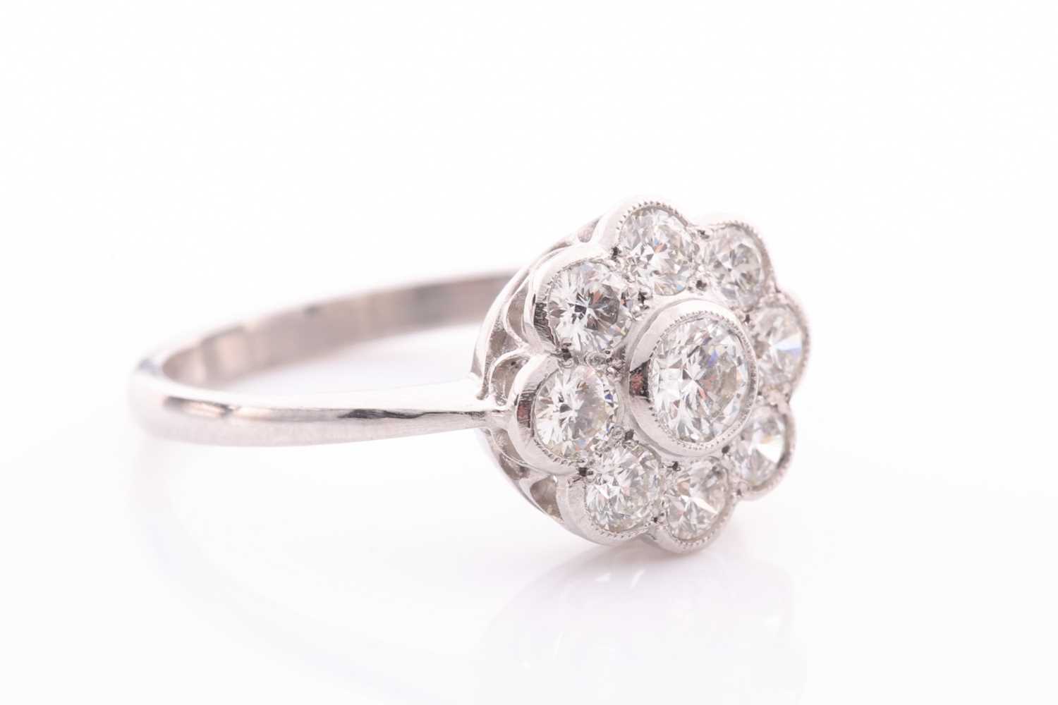 A platinum and diamond daisy cluster ring, set with round-cut diamonds of approximately 1.0 carats - Image 2 of 4