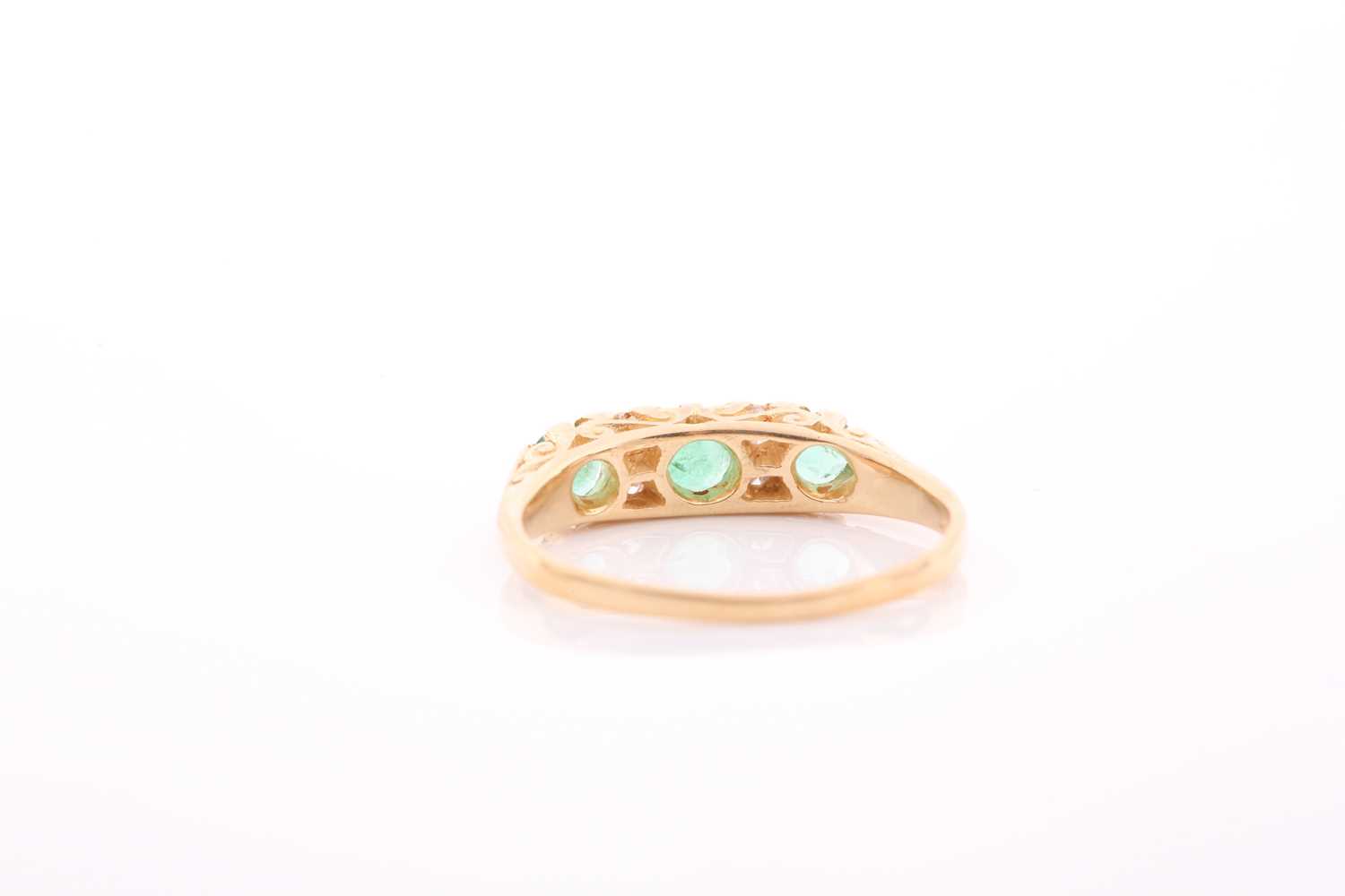 An early 20th century gold, emerald and diamond carved half-hoop ring, the three slightly - Image 2 of 4