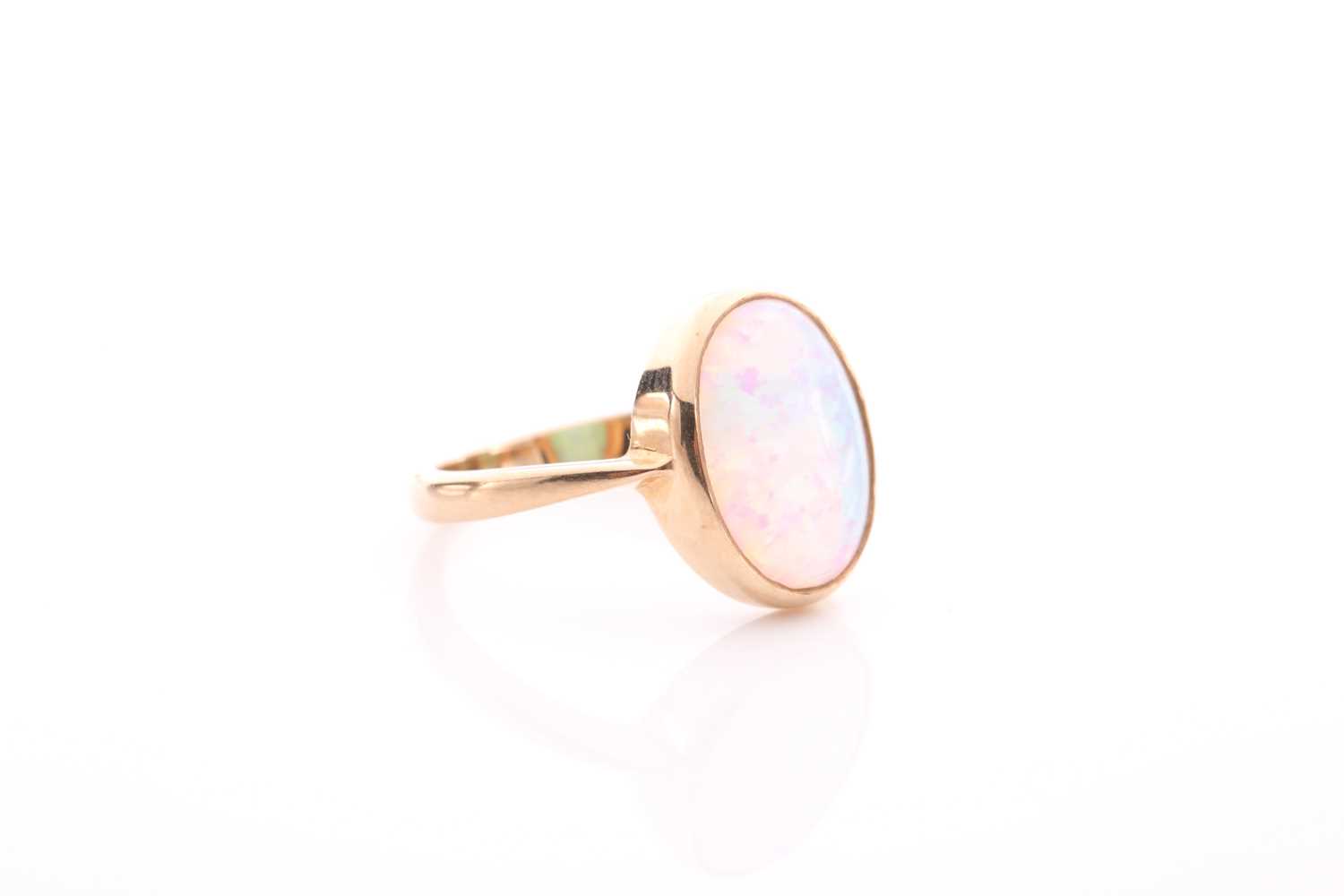 A single stone opal ring, the oval opal in rub-over mount to plain 9 carat gold shank, opal 14mm x - Image 3 of 4