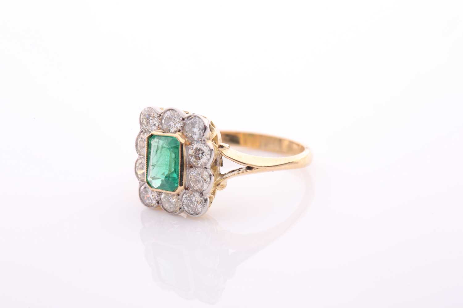 An emerald and diamond rectangular cluster ring, centred with an emerald-cut emerald, - Image 5 of 5