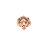 A lion's head ring; the carved head with flowing mane and round brilliant cut diamond set eyes and