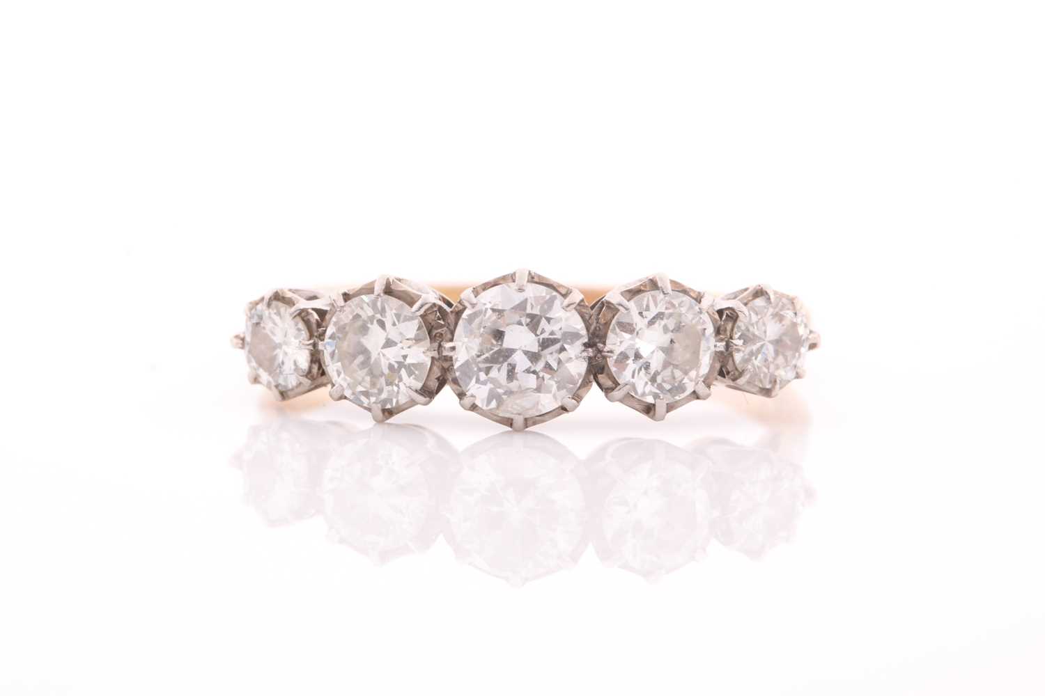 An early 20th century gold and diamond five stone ring, the graduated early round brilliants