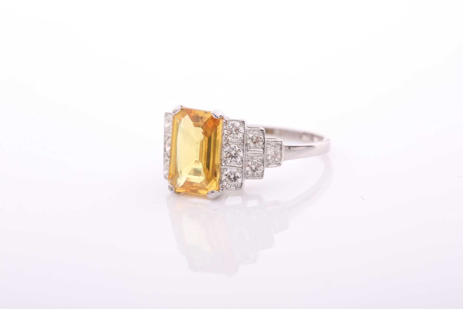 A modern treated yellow sapphire and diamond dress ring, centred with a rectangular step-cut - Image 2 of 4