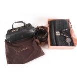 A Gucci blue and black leather handbag with two loop handles and zipped fastening in Gucci dust bag,