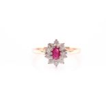 A ruby and diamond cluster ring set in yellow metal, the oval mixed cut ruby surrounded by ten round