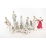 A Lladro porcelain figure group of a young lady hands clasped in prayer with her kneeling