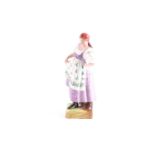 A Russian Gardner (Moscow) biscuit porcelain figure, depicting a dancing peasant woman, standing and