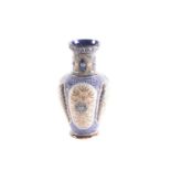 A Doulton Lambeth lobed vase, the rim with moulded leaves above the neck with foliate medallions,