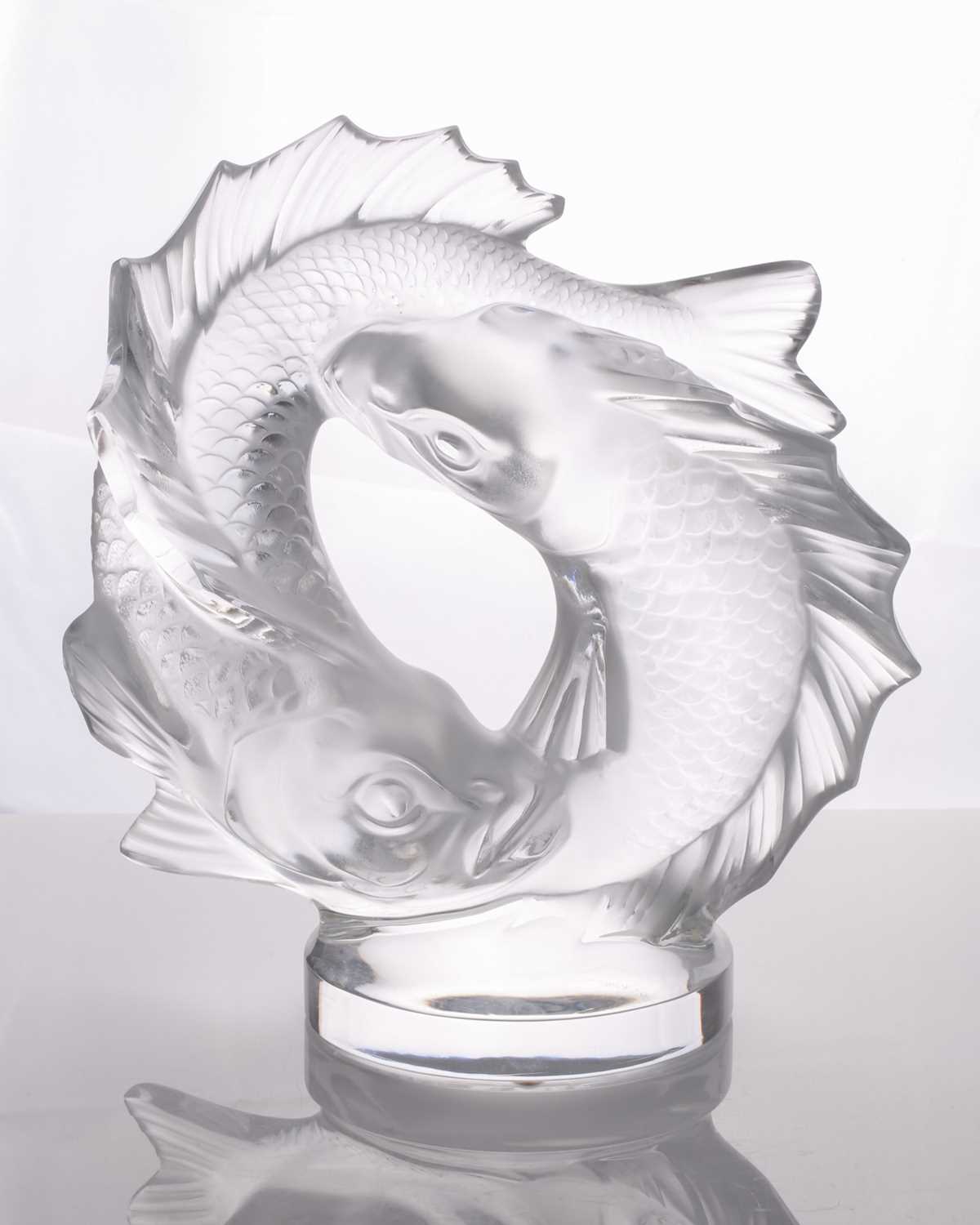 A Lalique double fish sculpture of a pair of writhing fish on a circular base, 28 cm high x 25 cm