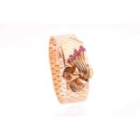 A vintage gold and ruby bracelet; the flat hexagonal articulated bracelet with chevron buckle