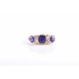 An 18ct yellow gold, diamond, and sapphire ring, set with three mixed-cut sapphires and four old-cut