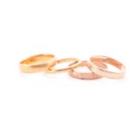 A 22ct yellow gold ring, size M 1/2, together with a thinner 22ct yellow gold band, size L, and