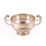 A silver two handled trophy bowl; London 1926 by Wakeley and Wheeler; circular with band to belly,