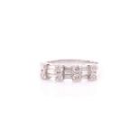 A diamond half hoop ring; comprising two rows of alternating round brilliant cut diamonds and