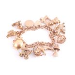 A 9 carat gold charm bracelet, the curb pattern bracelet suspending various charms including the old