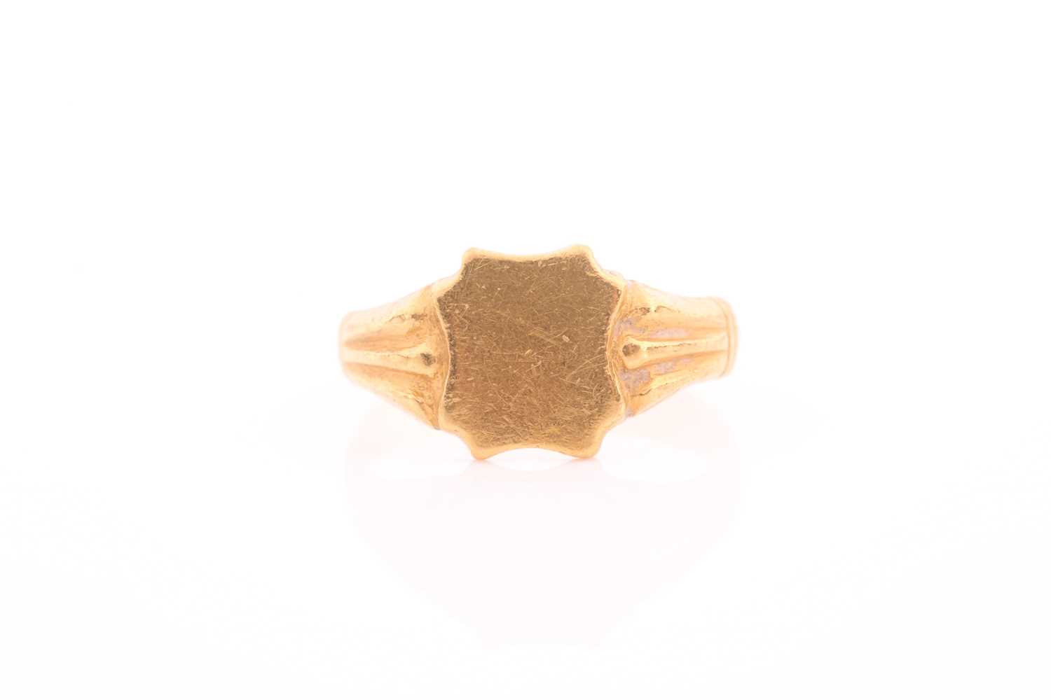 A yellow metal signet ring, with shield-shaped vacant cartouche, unmarked, size M 1/2.Condition