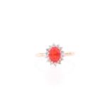 A 9ct yellow gold, fire opal, and white topaz cluster ring, the opal measuring approximately 8.2 x