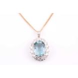 A yellow metal, diamond, and aquamarine pendant, set with a mixed oval-cut aquamarine of