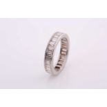 A white metal and diamond eternity ring, set with baguette-cut diamonds, unmarked (has been resized,