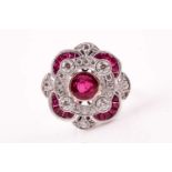 A Belle Epoque style ruby and diamond foliate cluster ring; the central round brilliant cut ruby