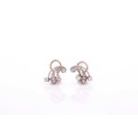 A pair of white metal and diamond earrings, of sprayed design, inset with round-cut diamonds,