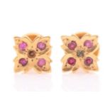 A pair of yellow metal and red paste stone quatrefoil earrings, with screwback fittings, 9 mm