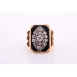 A yellow metal and diamond ring, the chamfered rectangular black onyx plaque, inset with old-cut