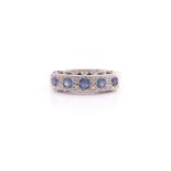 A sapphire and diamond half hoop ring, the five circular cut pale sapphires pavé set with ten
