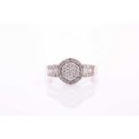 A 9ct white gold and diamond cluster ring, set with round brilliant-cut diamonds, the central